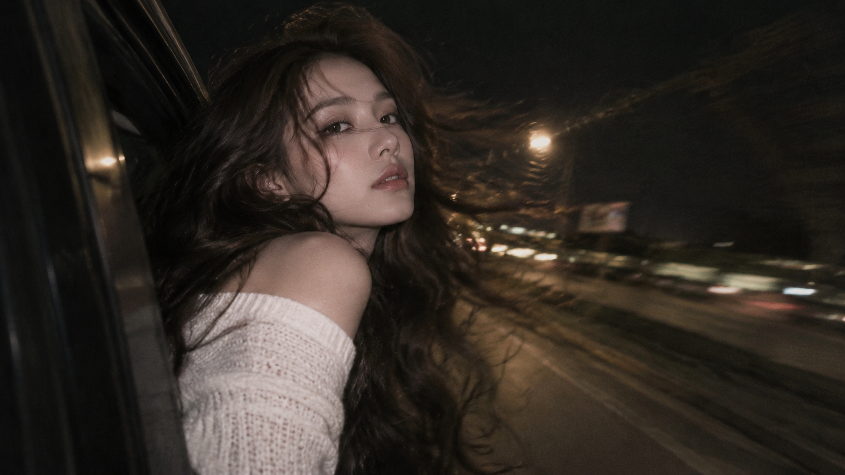 A vintage portrait leaning against the car window in the night breeze